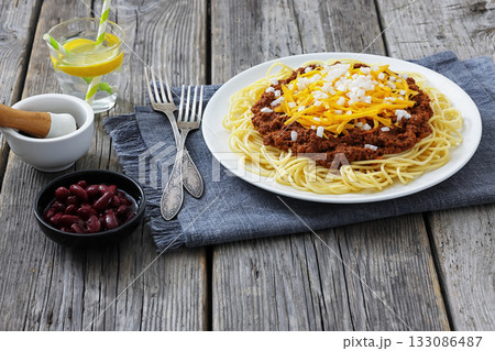 Cincinnati chili with spaghetti on white plate 133086487