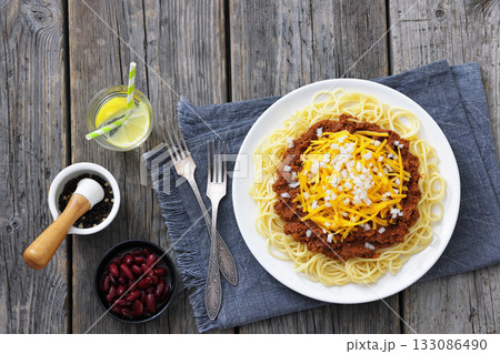 Cincinnati chili with spaghetti on white plate 133086490
