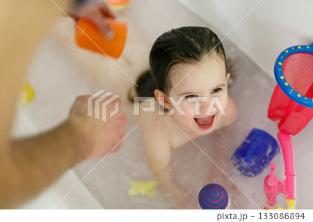 Bath time with laughing toddler in family bathroom Bath time with laughing toddler in family bathroom 133086894