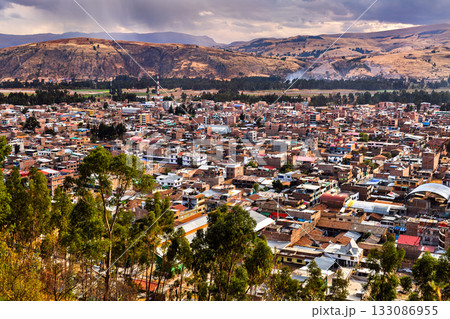 High-angle view of the city of Concepcion, Peru. The town is in Mantaro Valley, surrounded by the Andes mountains under a dramatic, cloudy sky 133086955