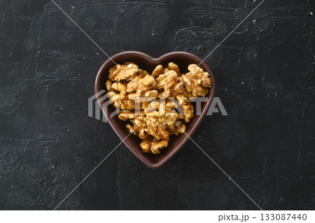 Inshell walnuts in a heart-shaped plate. Heart Nuts, Heart Health Products, Structured Walnuts Healthy food protein 133087440