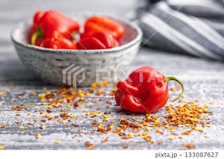 Red chili pepper habanero and chili flakes on kitchen table. 133087627