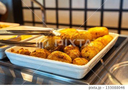 Potatoes baked in their skins in the hotel buffet 133088046
