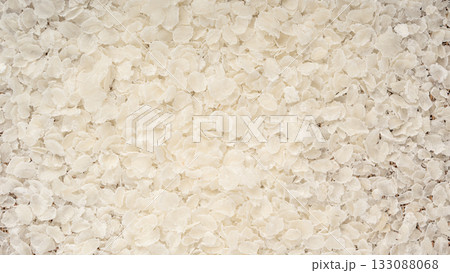 Raw flattened rice textured background. Dry rice flakes or poha pattern, Indian breakfast food Raw flattened rice textured background. Dry rice flakes or poha pattern, Indian breakfast food 133088068