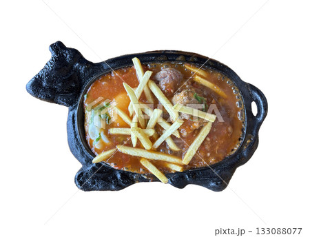Sizzling Vietnamese Bo Ne with beef, a fried egg, and fries on a hot cast iron platter 133088077