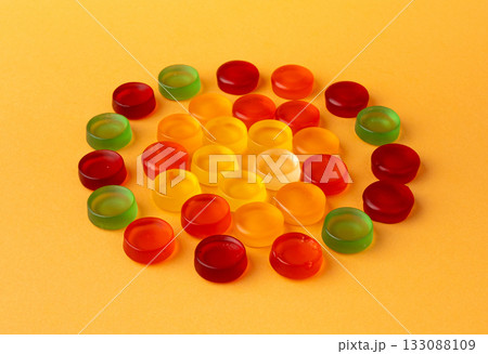 Round gummy candy pile. Chewing colorful marmalade pills, jelly gumdrops heap 133088109