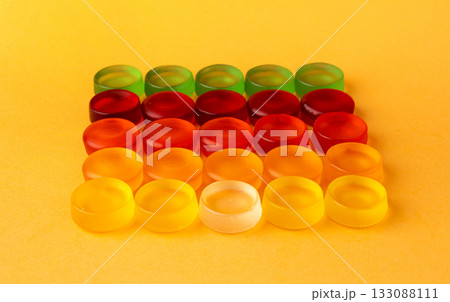 Round gummy candy pile. Chewing colorful marmalade pills, jelly gumdrops heap 133088111