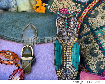 Handmade metal owl decoration with jewelry and fabric. Artisan craft, culture, and bohemian style accessories with ethnic aesthetic. 133088455