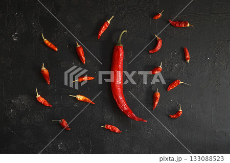 Fresh red hot chili peppers set, on black stone background, top view flat lay, with copy space for text 133088523
