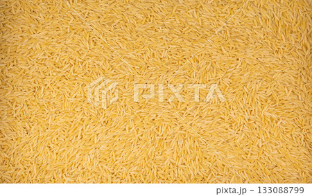 Raw orzo pasta, risoni or kritharaki pile 133088799