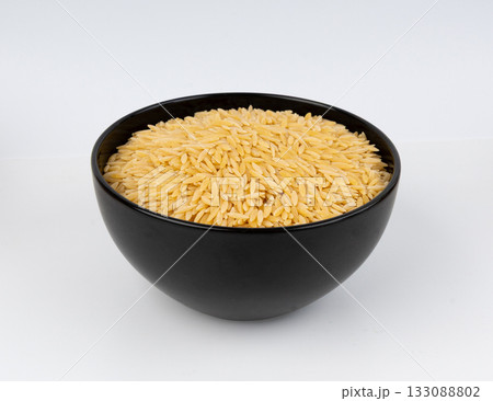 Raw orzo pasta, risoni or kritharaki pile 133088802