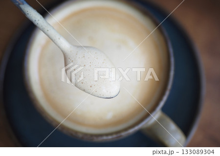 Creamy beverage served in a rustic cup at a cozy cafe Creamy beverage served in a rustic cup at a cozy cafe 133089304