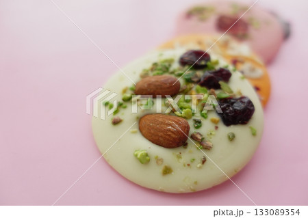 Colorful candy with nuts and fruits on pink Colorful candy with nuts and fruits on pink 133089354