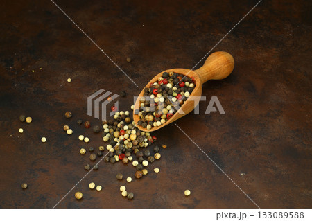 Pepper mix in scoop isolated on rusty background, top view 133089588