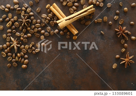 Cinnamon sticks and anise stars spices on roasted coffee beans background. Cinnamon sticks and anise stars spices on roasted coffee beans background. 133089601