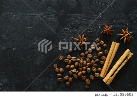Cinnamon sticks and anise stars spices on roasted coffee beans background. Cinnamon sticks and anise stars spices on roasted coffee beans background. 133089602
