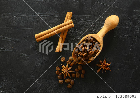 Cinnamon sticks and anise stars spices on roasted coffee beans background. 133089603