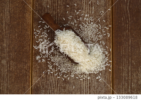 raw white rice on dark rustic wooden background 133089618