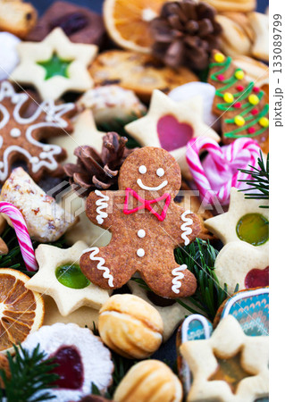 Gingerbread man and many different sweet Christmas cookies, close-up, top view, holiday concept Gingerbread man and many different sweet Christmas cookies, close-up, top view, holiday concept 133089799