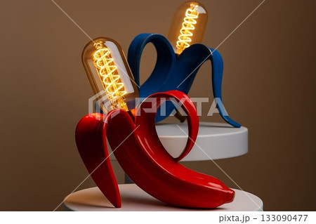 Unique interior decor with creative banana-shaped lamps in vibrant colors on display at a modern design exhibition Unique interior decor with creative banana-shaped lamps in vibrant colors on display at a modern design exhibition 133090477