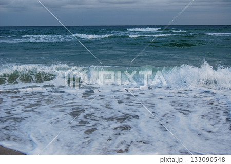 Beautiful seascape of the Black Sea. A seascape of the Black Sea with gentle waves lapping a sandy beach. Beautiful seascape of the Black Sea. A seascape of the Black Sea with gentle waves lapping a sandy beach. 133090548