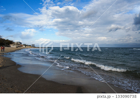 Beautiful seascape of the Black Sea. A seascape of the Black Sea with gentle waves lapping a sandy beach. Beautiful seascape of the Black Sea. A seascape of the Black Sea with gentle waves lapping a sandy beach. 133090738