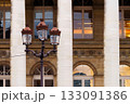 Historic building columns and ornate street lamp in city 133091386