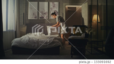 Maid With Housekeeping Trolley Changes Bedding After Guests Depart Maid With Housekeeping Trolley Changes Bedding After Guests Depart 133091692