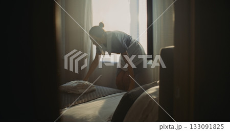 Hotel Room Attendant In Uniform Prepares Accommodation For Next Guest Hotel Room Attendant In Uniform Prepares Accommodation For Next Guest 133091825