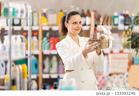 Adult woman buyer chooses cosmetics gift set Adult woman buyer chooses cosmetics gift set 133093246