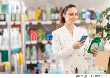 Adult woman scanning qr code for dishwashing 133093325
