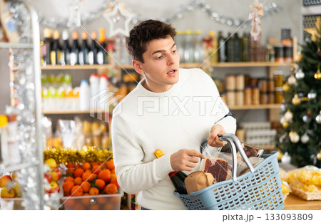 Man with a grocery basket full of food for the holiday Man with a grocery basket full of food for the holiday 133093809