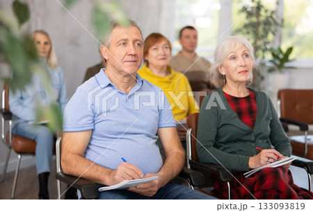Group of mature students attending lecture in college Group of mature students attending lecture in college 133093819