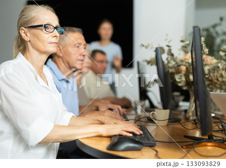 Computer literacy lessons in nursing home for elderly. Mature woman at computer Computer literacy lessons in nursing home for elderly. Mature woman at computer 133093829
