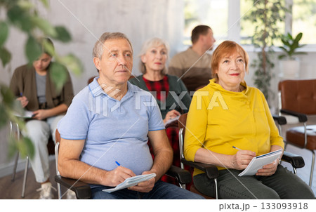Group of mature students attending lecture in college Group of mature students attending lecture in college 133093918