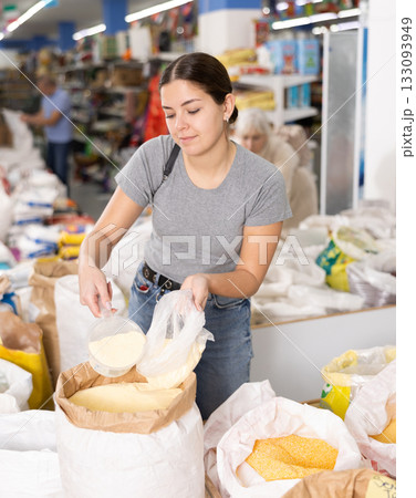 Young woman purchaser buying sugar sand in supermarket 133093949