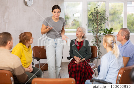 Young female tutor teaching language to group of mature students Young female tutor teaching language to group of mature students 133093950