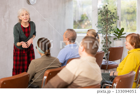 Older female teacher explaining subject to mature students Older female teacher explaining subject to mature students 133094051