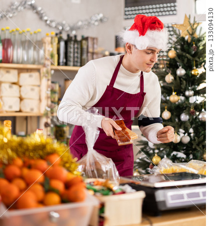 Male salesman behind a grocery counter 133094130