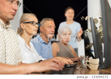 Elderly woman studying at computer course in group Elderly woman studying at computer course in group 133094172