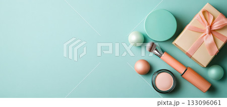 Stylish makeup flat lay featuring cosmetics, a gift box, and pastel colors against a soft teal background. Stylish makeup flat lay featuring cosmetics, a gift box, and pastel colors against a soft teal background. 133096061