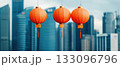 Vibrant orange lanterns against a modern city skyline, symbolizing festive celebration. 133096796