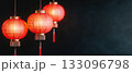 Beautiful red lanterns hang elegantly against a dark backdrop, symbolizing light and celebration. 133096798
