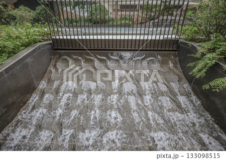 Oct 29 2025 Urban Water Feature With Tiered Stone Surface, Metal Fence Oct 29 2025 Urban Water Feature With Tiered Stone Surface, Metal Fence 133098515