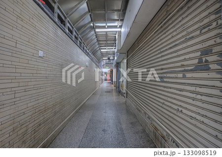 Oct 29 2025 Long Indoor Corridor With Closed Shutters On The Right 133098519