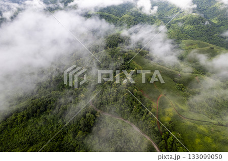 Landscape of Morning Mist with Mountain Layer. mountain ridge and clouds in rural jungle bush forest Landscape of Morning Mist with Mountain Layer. mountain ridge and clouds in rural jungle bush forest 133099050