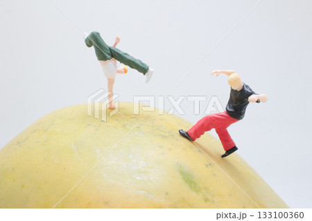 Giant Mango With Tiny People Running Beside 133100360