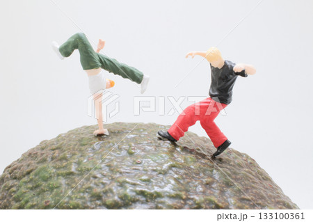 Miniature Figures On Mossy Rock Perform Playful 133100361