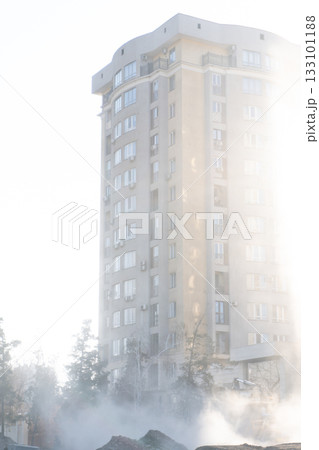 High-rise apartment building in sunlight and mist High-rise apartment building in sunlight and mist 133101188