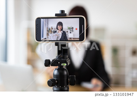 Caucasian woman recording financial literacy video showcasing cash, providing investment tips, income insights Caucasian woman recording financial literacy video showcasing cash, providing investment tips, income insights 133101947